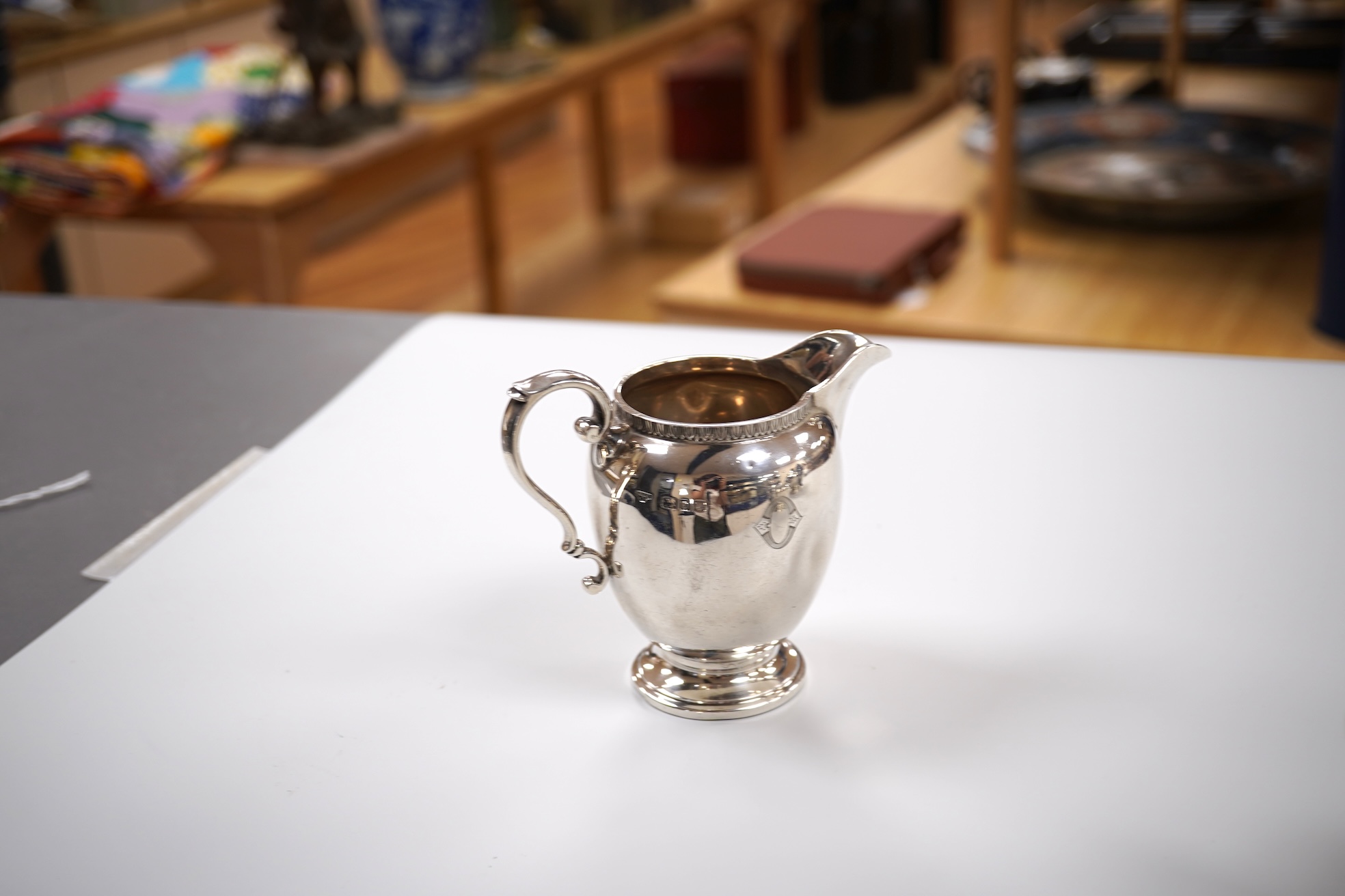 A George V silver circular three piece tea set, with engraved initial, Fenton, Russell & Co Ltd, London, 1927, gross weight 32.4oz.